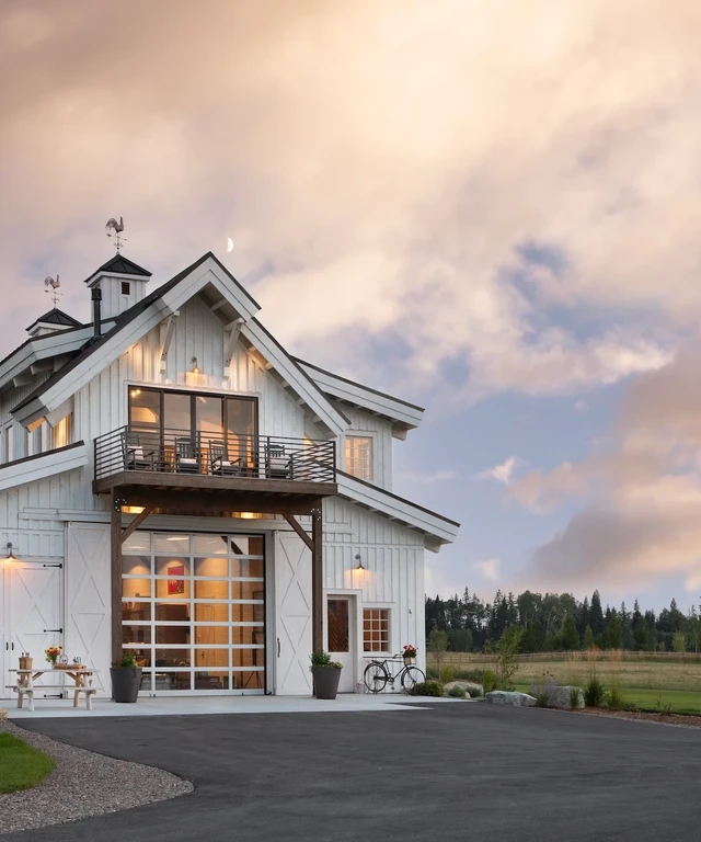 Tate Interiors Montana Interior Design Hawks Homestead Barn Exterior White Siding Dusk