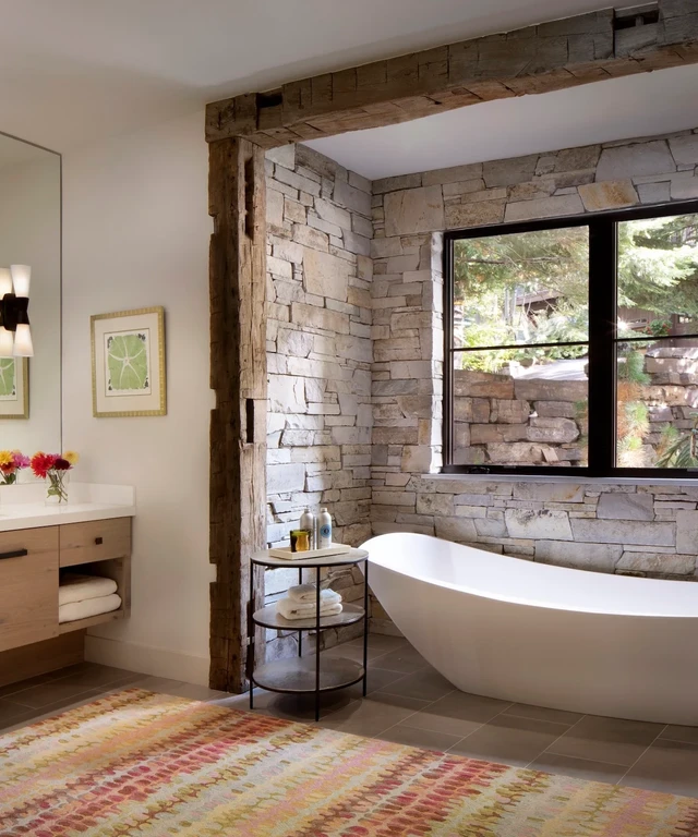 Tate Interiors Montana Interior Design Sisters Cabin Bathroom Stone Wall Freestanding Tub