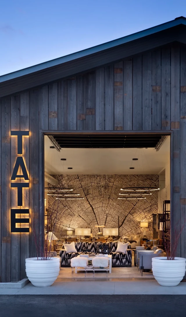 Tate Interiors Montana Interior Design Whitefish Showroom Exterior Storefront Dusk Interior Visible
